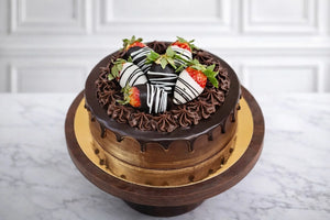 Chocolate cake with strawberries on a marble surface