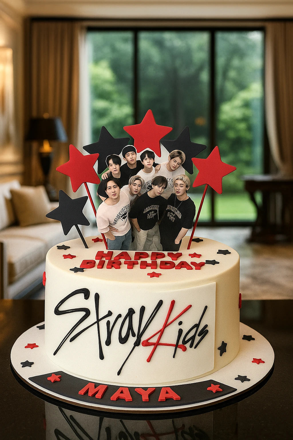 Birthday cake with Stray Kids members on top, decorated with stars and 'Happy Birthday' text, in a room setting.