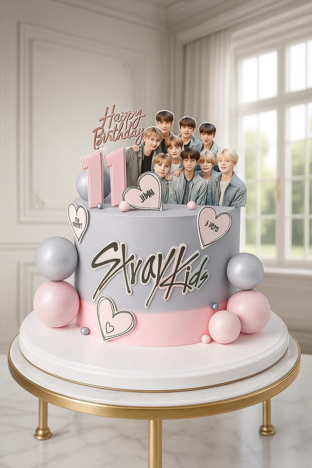 Large birthday cake with Stray Kids on top in a decorated room